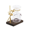 A miniature hand-brewed coffee stand set for dollhouse featuring a clear glass teapot and a brass stand.