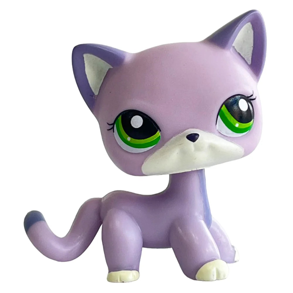 A purple and white bobble head pet figurine with large green eyes.