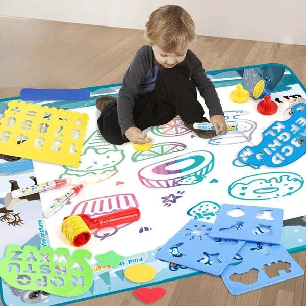 A child is drawing on a colorful magic drawing mat with various tools and shapes.