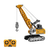 A yellow mini RC excavator model with a hydraulic arm and bucket, shown alongside its remote control transmitter.