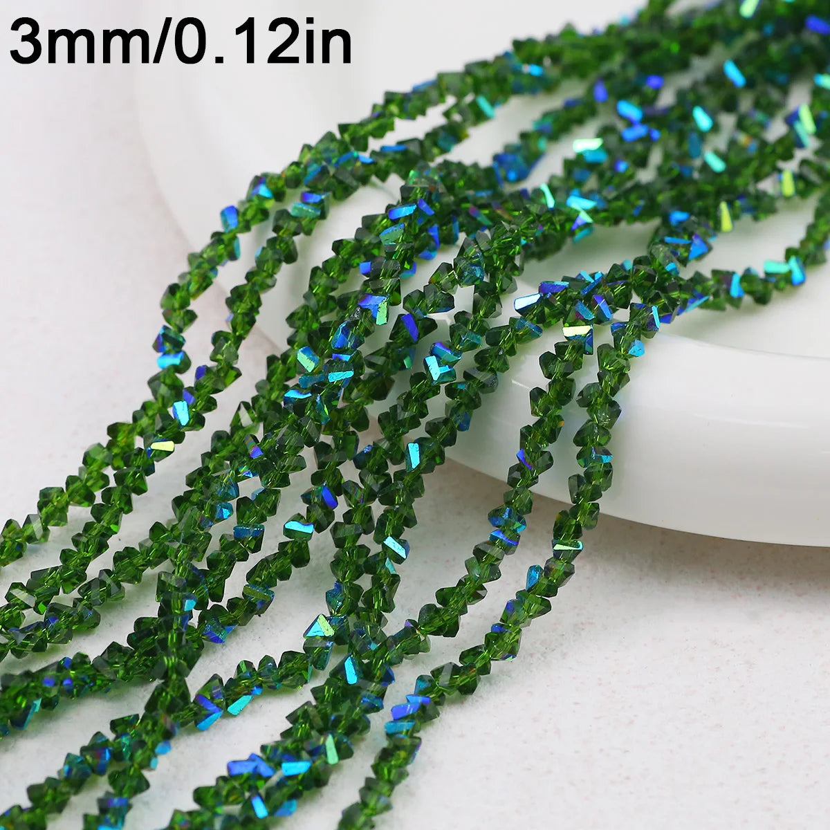 Green crystal triangle beads measuring 3mm or 0.12 inches strung together for jewelry making