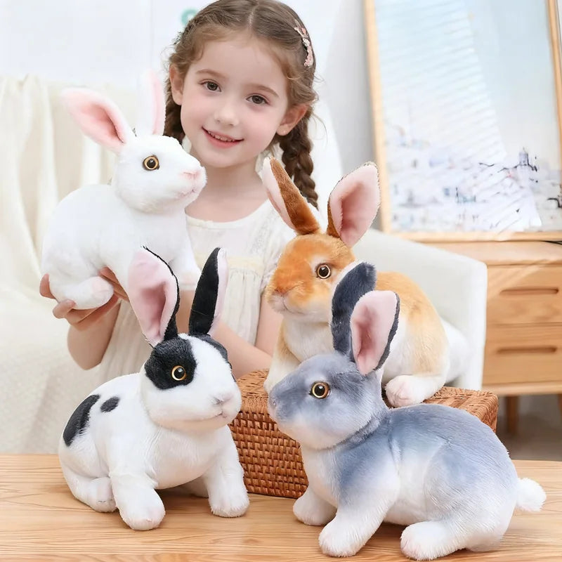 A collection of cute white, orange, and gray rabbit plush toys sitting on a wooden surface.