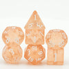 A set of seven translucent orange polyhedral dice, including a tetrahedron and a dodecahedron.