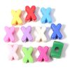 A collection of colorful acrylic letter X beads in various shades including yellow, red, blue, pink, and green.