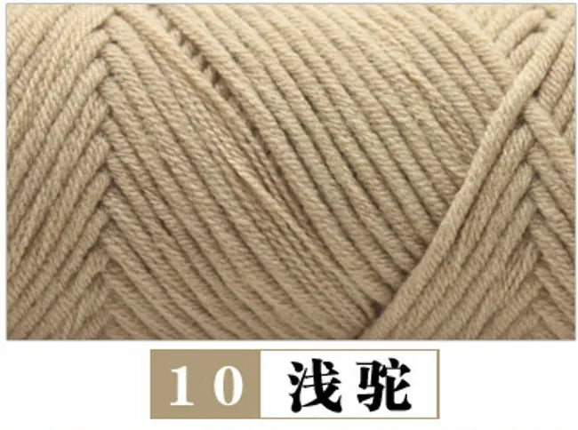 A close-up of a beige yarn, likely milk cotton, shown in a twisted or cable knit texture.