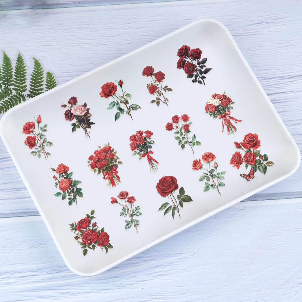 A white rectangular plate decorated with a pattern of vintage red rose illustrations.