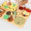 A wooden busy board for children featuring various musical and sensory activities like puzzles and levers.
