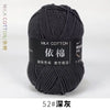 A skein of dark gray milk cotton yarn labeled with Chinese text and a size designation.