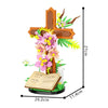 A wooden religious Easter cross with floral decorations and a Bible open book included in a building block kit.