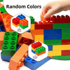 A hand is placing red blocks onto a colorful stack of wooden building blocks showing square and rectangle shapes.