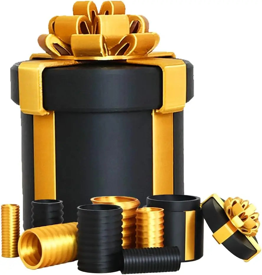 A set of nested black and gold screw gift boxes with decorative ribbon and cylindrical components.