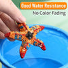 A hand holds a colorful starfish-shaped craft item in blue water, demonstrating good water resistance.