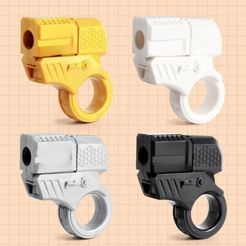 Four mini shell-ejecting fidget pistols in yellow, white, silver, and black plastic.