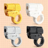 Four mini shell-ejecting fidget pistols in yellow, white, silver, and black plastic.