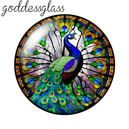 A round glass cabochon featuring a vibrant blue peacock with iridescent green and gold feathers.