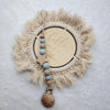 A personalized wooden baby pacifier clip featuring silicone beads and a natural fiber wreath with the words hello world