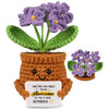 Handmade crochet flower plant decoration with purple flowers in a brown pot