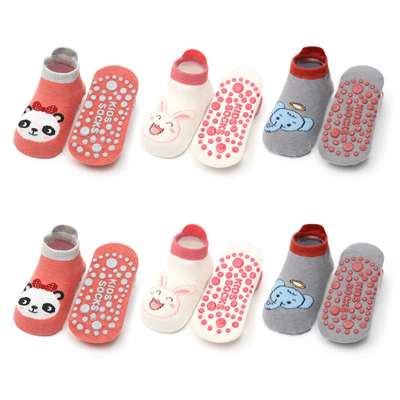 A pack of six pink and gray cotton socks featuring cartoon animals with non-slip grips for kids.