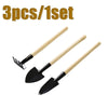 A set of three mini gardening tools with wooden handles and black blades.