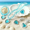 A set of five sparkling blue and silver princess jewelry accessories including necklaces and earrings displayed on a white di