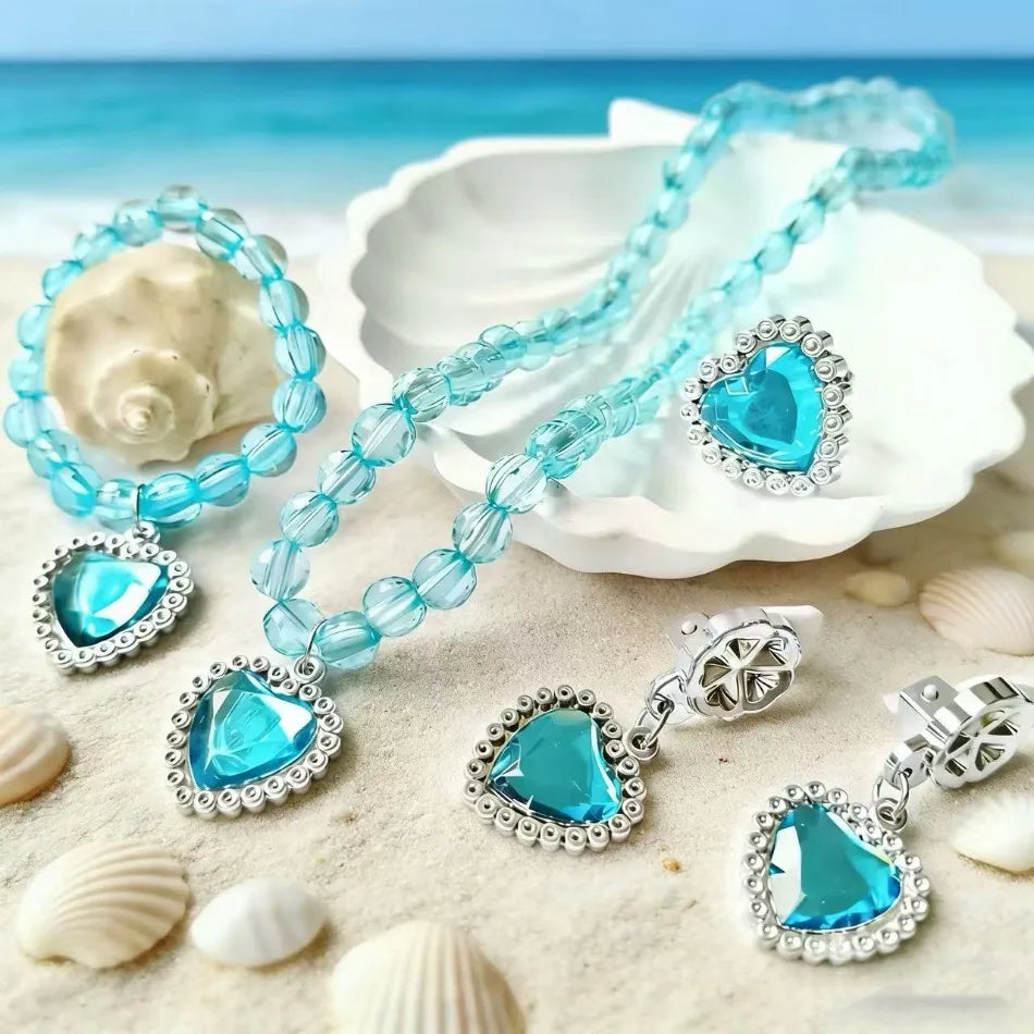 A set of five sparkling blue and silver princess jewelry accessories including necklaces and earrings displayed on a white di
