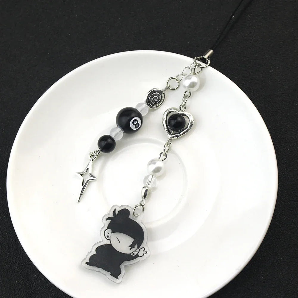 Anime-inspired keychain featuring a black silhouette charm and pearl beads on a black cord