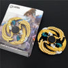 A gold-colored metal fidget spinner featuring a dragon design with blue accents, packaged in an anime style box.