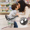 A mother is securing her child in a waterproof shopping cart seat cover while shopping.