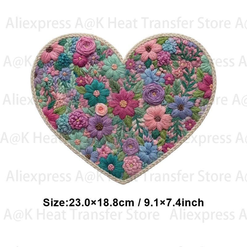 A heart-shaped floral letter bow iron-on patch featuring pink, purple, and green flowers for DIY clothing.