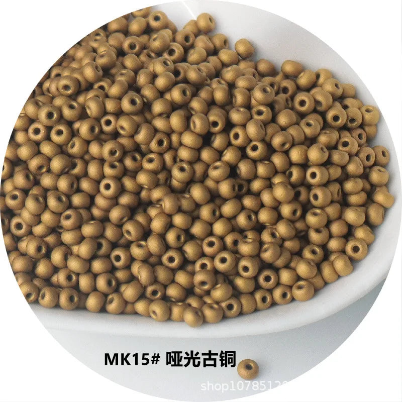 A pile of gold-colored electroplated metallic glass beads for jewelry and crafting.