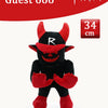 A black plush toy resembling a rabbit with red ears and features, displayed against a red background.