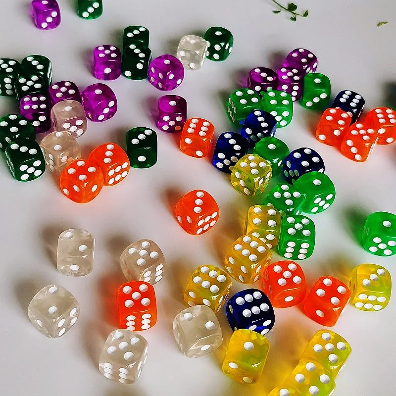 A collection of colorful transparent dice in various shades of green, purple, orange, and yellow scattered on a white surface