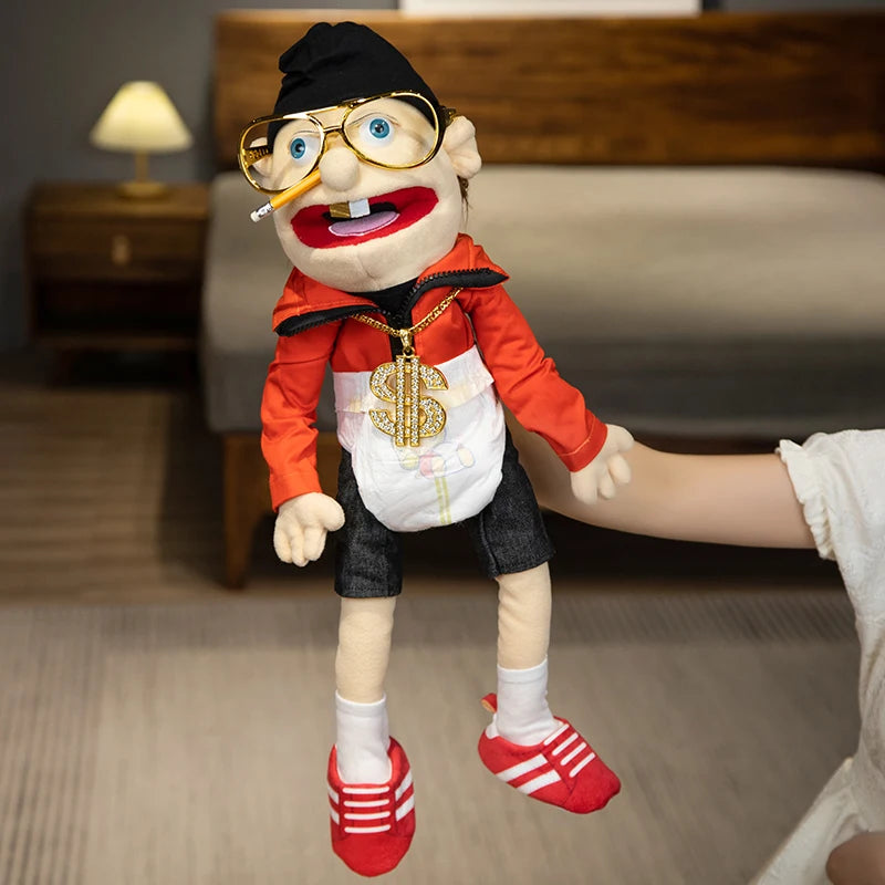 A realistic plush hand puppet resembling a man with glasses and a beard wearing an orange shirt and black hat.