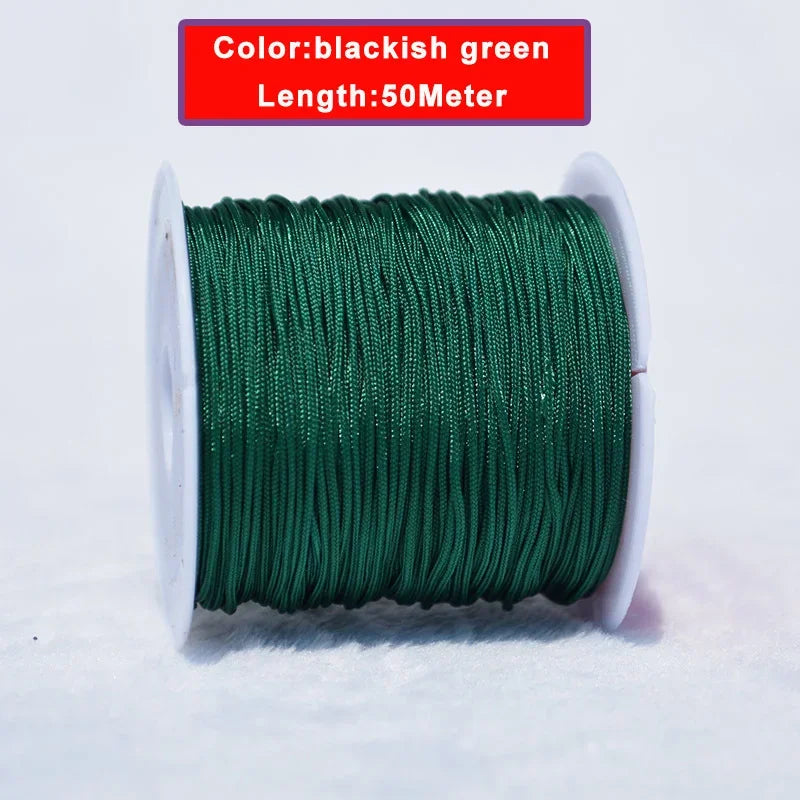 A spool of blackish green nylon knotting cord, 50 meters long, lying on a white surface.