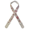An adjustable woven guitar strap featuring a light beige background with red and green floral embroidery and leather accents.