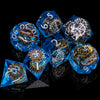 A collection of blue resin dice with gold accents, displayed against a black background.