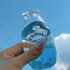 A hand holds a clear blue bottle labeled Chiboki, which is a fruit bottle stress ball or squishy fidget toy.