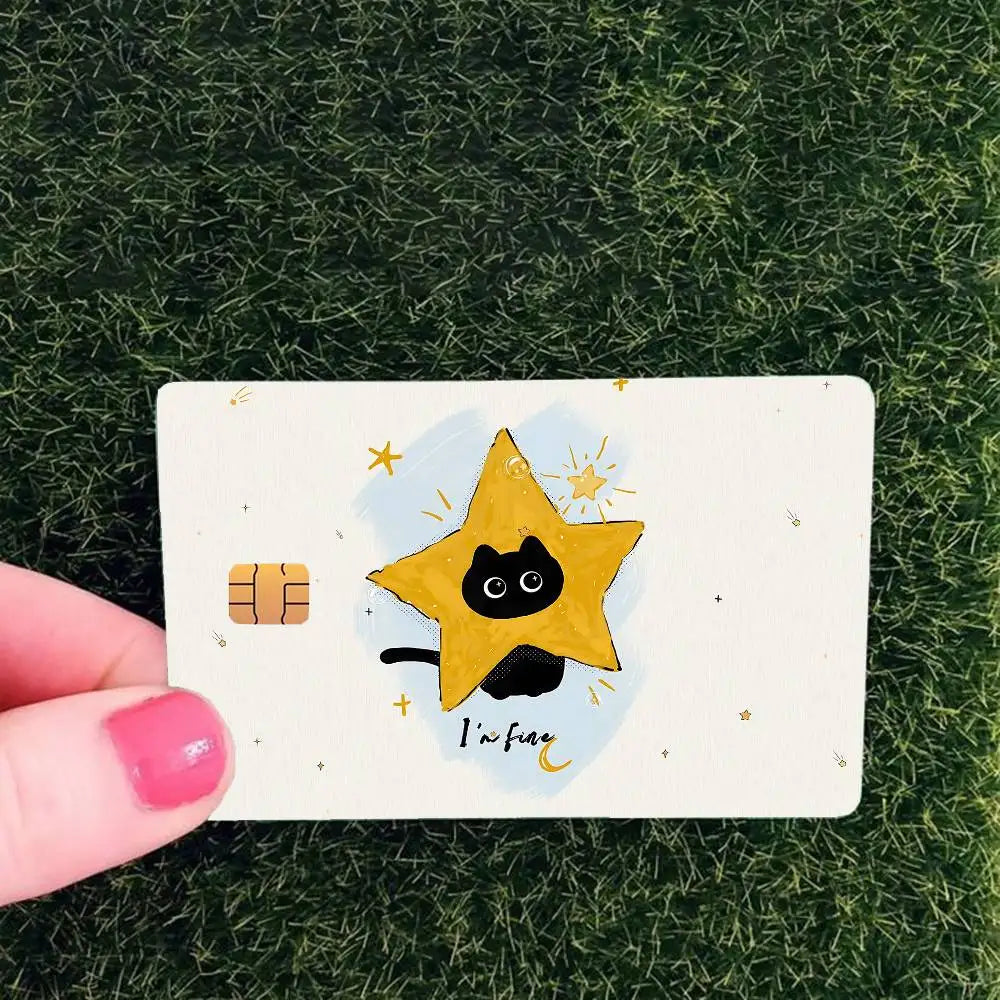 A yellow star with a black cat face is drawn on a white card against a green textured background.