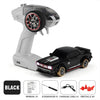 A black mini 4WD remote control stunt car and its white controller are shown with various accessories.
