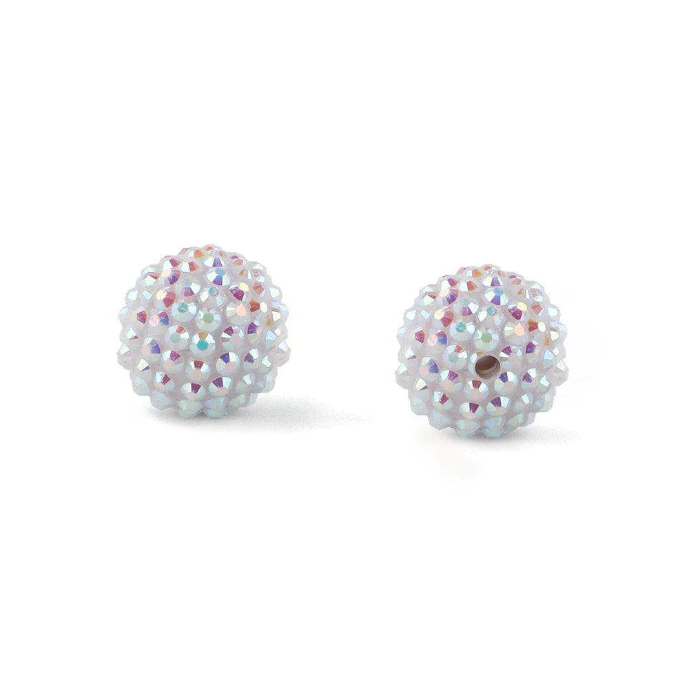 A pair of spherical ball beads made of iridescent white and pink rhinestones for jewelry making
