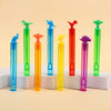 A collection of colorful dinosaur-shaped bubble bottles in various shades of green, yellow, orange, and purple.