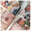 A close-up view of a set of vintage patterned washi tape rolls for crafting and journaling