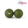 Two round, olive green silicone beads with a hole, shown against a white background.