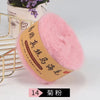 Pink mohair blended yarn for knitting shawls and sweaters shown next to a gold wire rack.