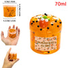 A jar of orange jelly slime with fruit decorations, showing the texture and scent kit.