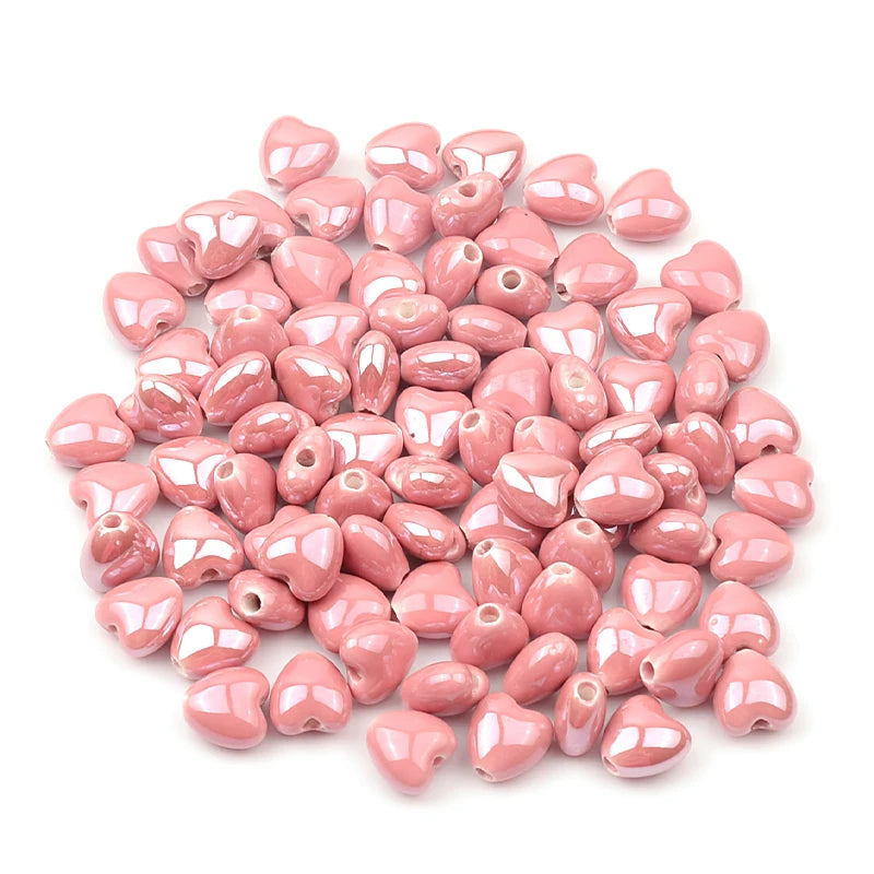 A pile of pink heart-shaped acrylic beads for jewelry making