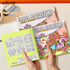 A hand holds a pink coloring book titled Mom Moments Fuzzy Buddies Coloring Book with various cartoon illustrations.