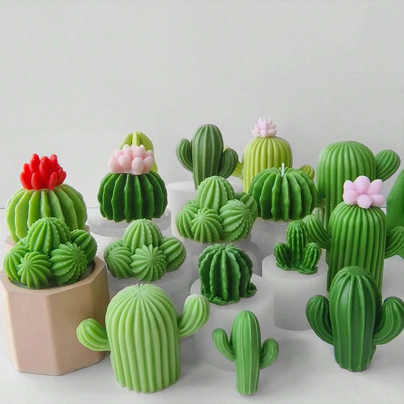 A collection of green and pink silicone cactus and succulent molds used for crafting candles, soap, and plaster.