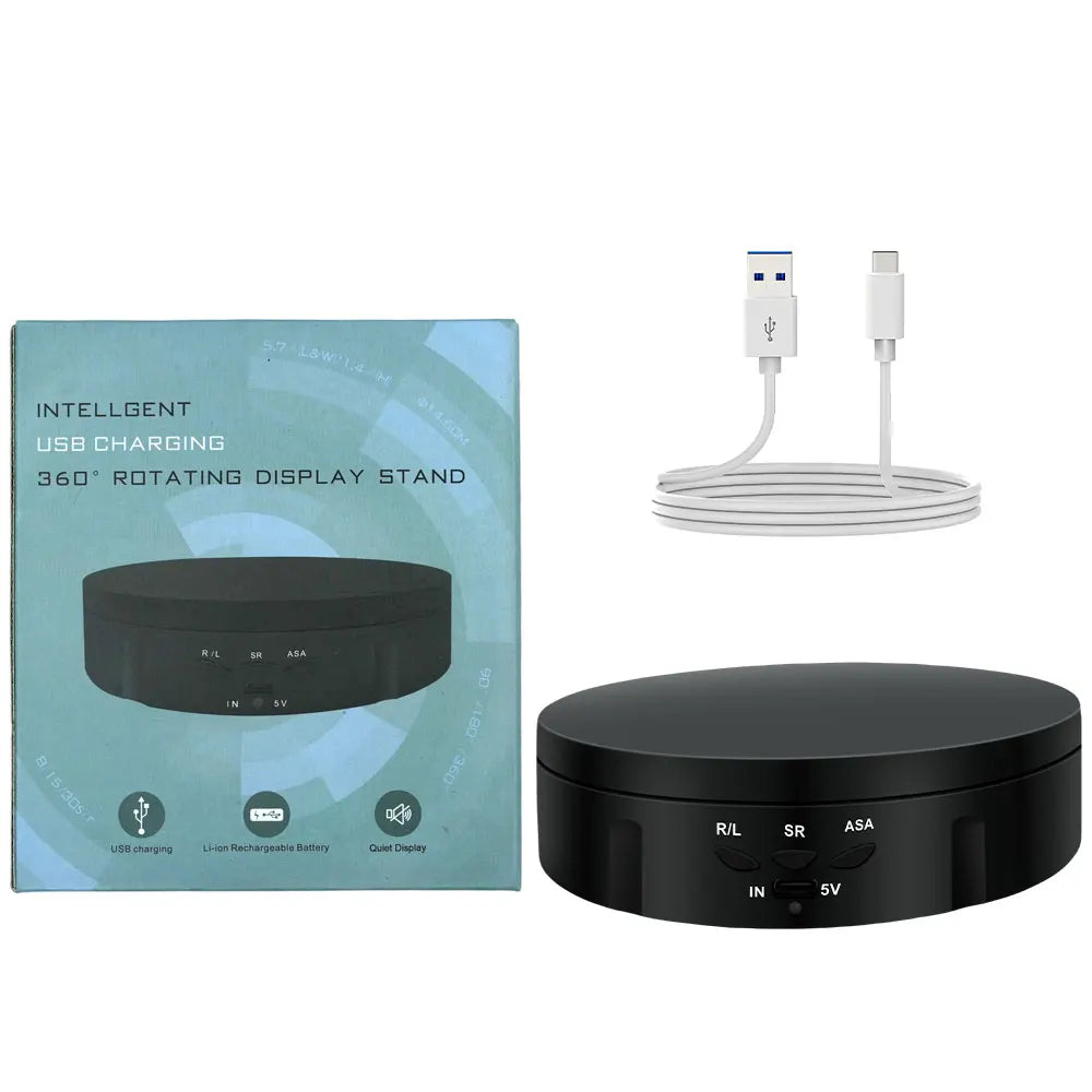 A black USB charging stand with a rotating display, showing the device and its charging cable.