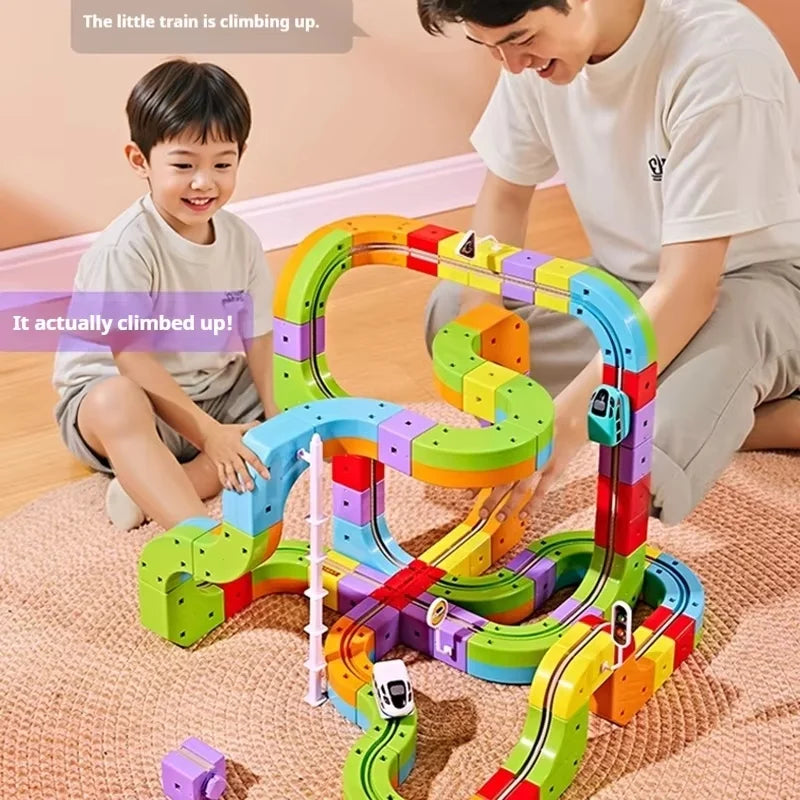 A child is playing with a colorful DIY magnetic track train set made of flexible plastic pieces on a carpet.